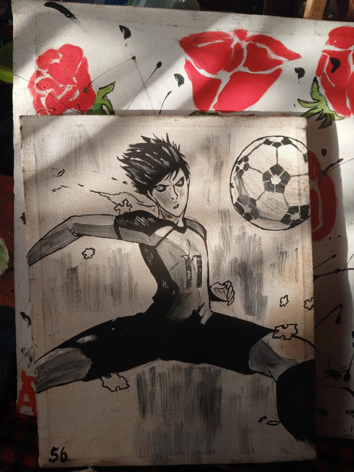 Monochrome manga-style painting of a footballer striking a ball, in greyscale on raw canvas